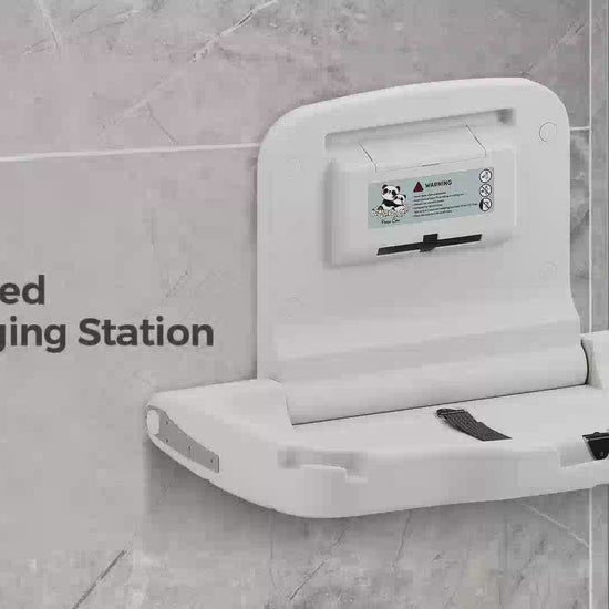 Wall mounted diaper changing station installed in a commercial restroom
