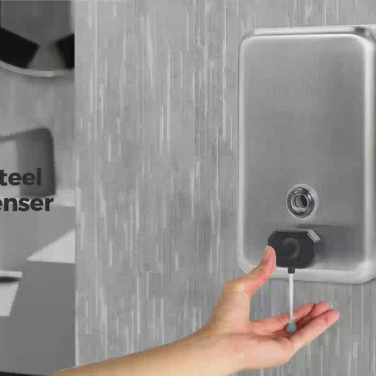 Hand using ST1100V manual soap dispenser on a restroom wall
