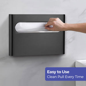 Hand pulling disposable paper covers from the black toilet paper seat cover dispenser
